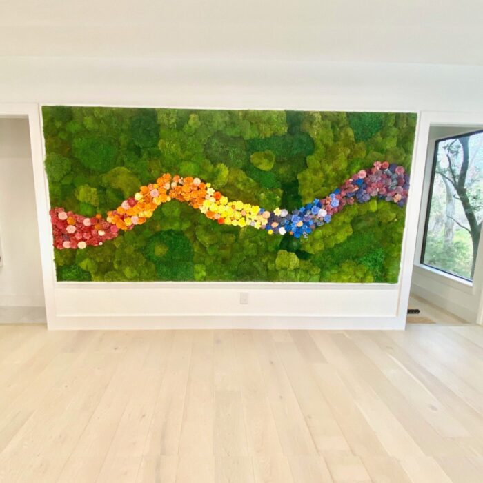 A large moss artwork with flowers in a modern space