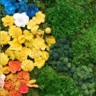 A large moss artwork with flowers in a modern space
