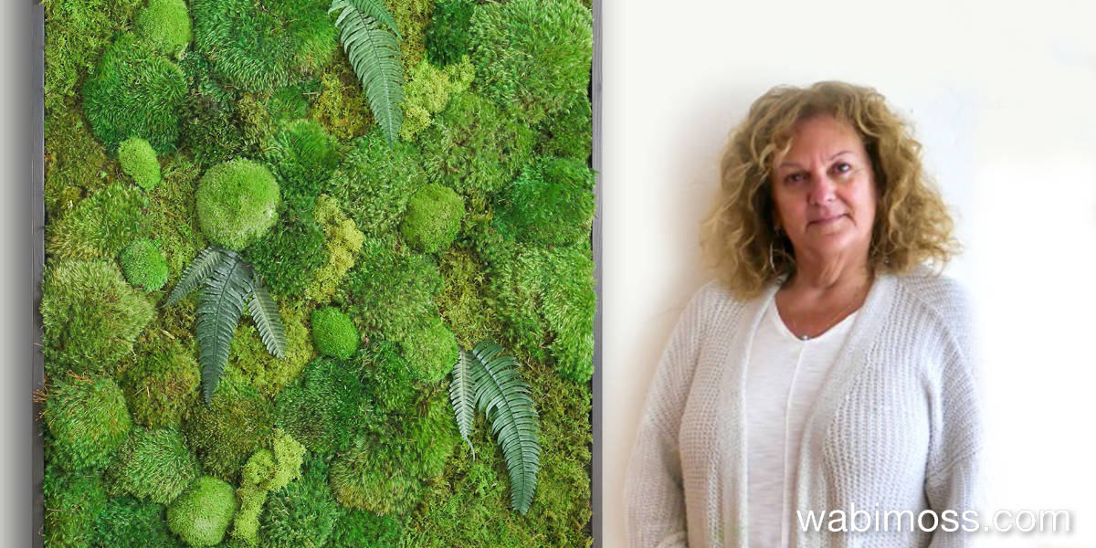 Geri Riehl standing next to her moss artwork. She is the artist at wabimoss.